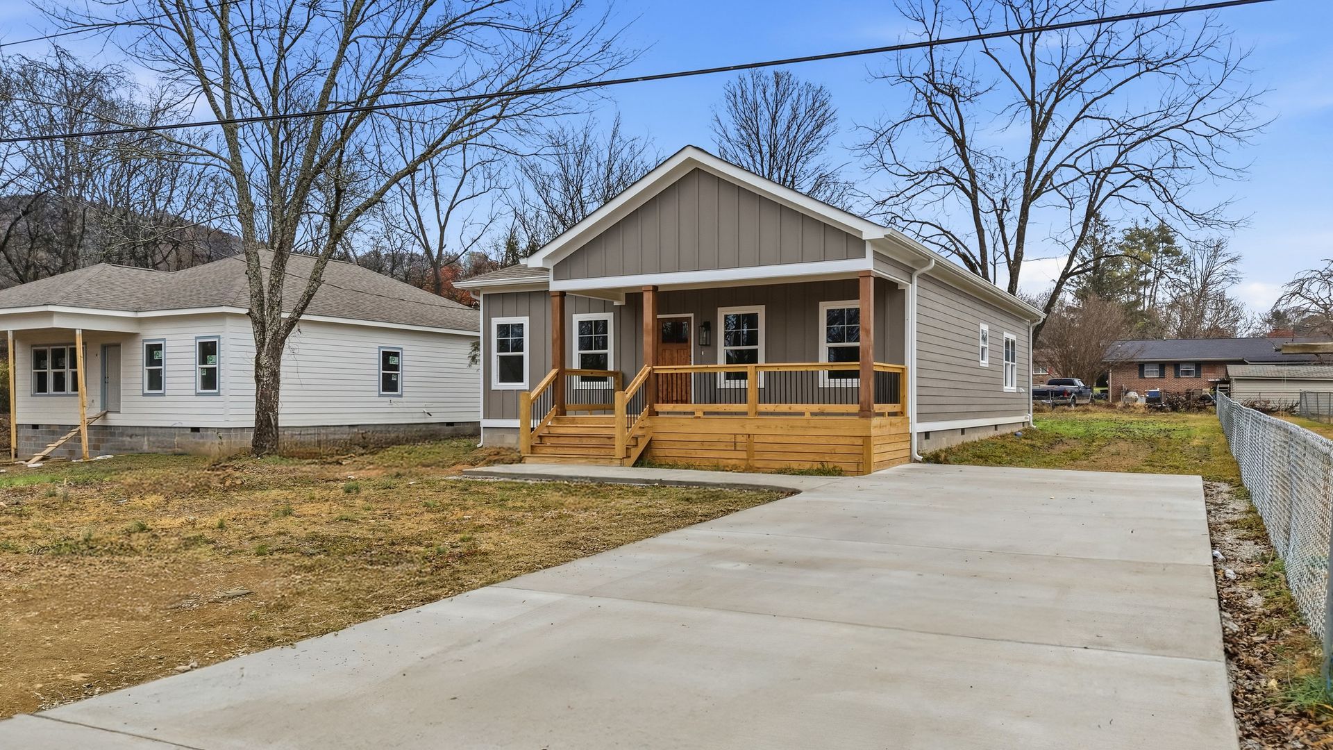 Gray one-story home with a covered front porch and a concrete driveway